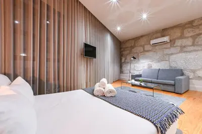 a hotel room with a bed and a couch at ON Apartments - Free Parking & Pet Friendly in Porto