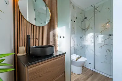 a bathroom with a sink and a toilet and a mirror at Oporto Nura House Duplex Downtown in Porto
