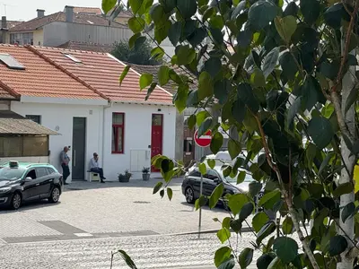 a building with cars parked in a parking lot at CreaConfort Casa Boa Jóia de Campanhã in Porto