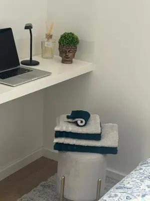a pile of towels sitting on top of a trash can at CreaConfort Casa Boa Jóia de Campanhã in Porto