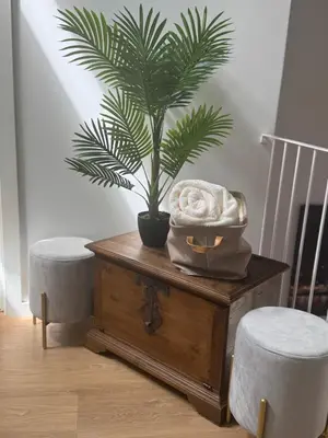 a palm tree on a table with a plant at CreaConfort Casa Boa Jóia de Campanhã in Porto