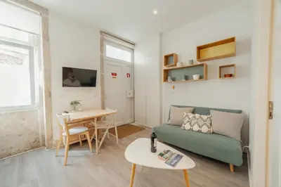 a living room with a couch and a table at Downtown Cosy Apartment by Vacationy in Porto