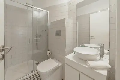 a bathroom with a sink and a toilet and a shower at Downtown Cosy Apartment by Vacationy in Porto