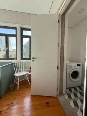 an open door to a laundry room with a washing machine at Catarina de Alexandria by Porto Stories in Porto