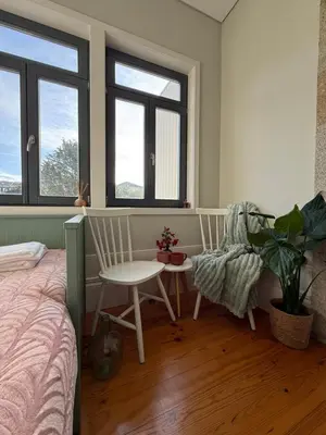 a bedroom with a bed and two chairs and a table at Catarina de Alexandria by Porto Stories in Porto