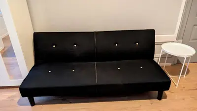 a black couch in a room with a white table at Riko Guest House 2 in Porto