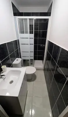 a bathroom with a white sink and a toilet at Riko Guest House 2 in Porto