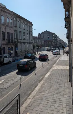 a city street with cars parked on the road at Riko Guest House 2 in Porto
