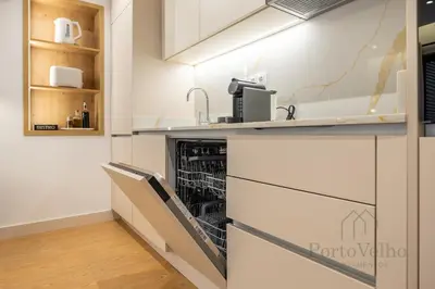a table and chairs with a table and a window at Nicos Garden Apartment - Porto Velho Apt in Porto
