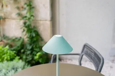 a lamp sitting on top of a table with a chair at DPV Residences - Studio CA/C1 in Porto