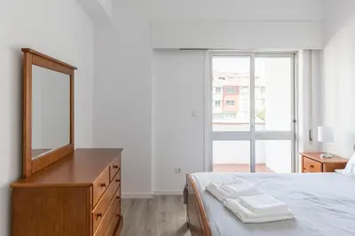 a white bathroom with a shower and a sink at Vilar 210 in Porto