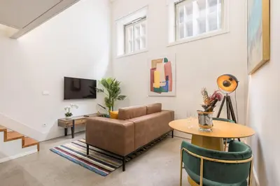 a living room with a couch and a table at Design loft, Downtown Porto in Porto
