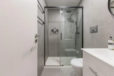 a bathroom with a shower with a toilet and a sink at Design loft, Downtown Porto in Porto