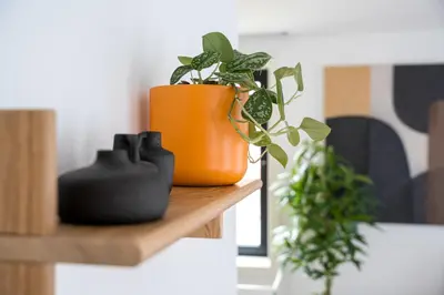 a wooden shelf with a vase on a wall at Brand new luxurious 2-Bedroom Duplex in Porto