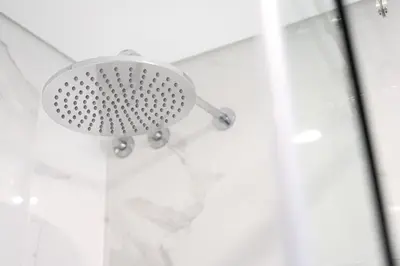 a bed with a white pillow and a lamp on a table at Brand new luxurious 2-Bedroom Duplex in Porto