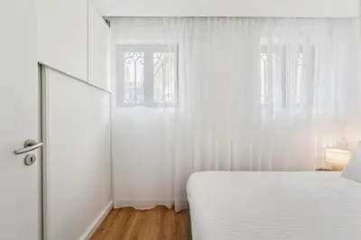 a dining room with a wooden table and chairs at Brand new luxurious 2-Bedroom Duplex in Porto