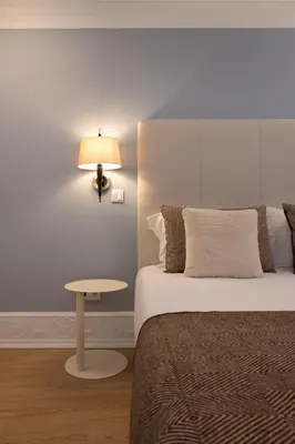 a bedroom with a bed and a lamp and a table at Ribeira Apartments Flores in Porto