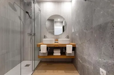 a bathroom with two sinks and a mirror at Ribeira Apartments Flores in Porto