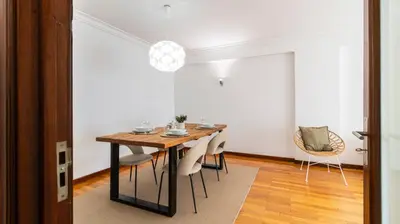 a dining room with a table and chairs at Charmy Rodrigues Lobo Apartments in Porto