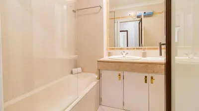 a bathroom with a tub and a sink and a bath tub at Charmy Rodrigues Lobo Apartments in Porto