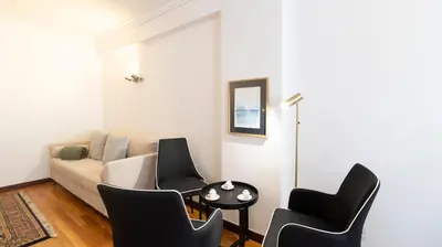 a living room with a couch and chairs and a table at Charmy Rodrigues Lobo Apartments in Porto