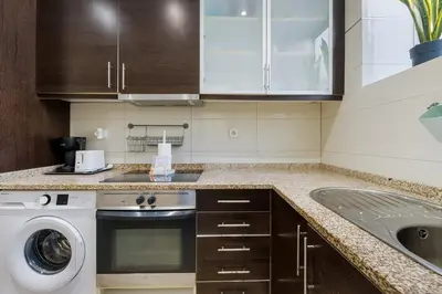 a kitchen with a washing machine and a sink at GuestReady - Relaxing Place with Terrace in Porto