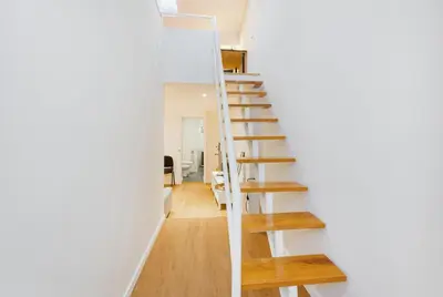 a staircase in a house with a mirror at GuestReady - Relaxing Place with Terrace in Porto