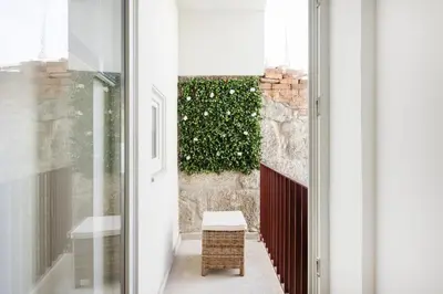 a white kitchen with a stove and a sink at Studio Glow | 111 Collection in Porto