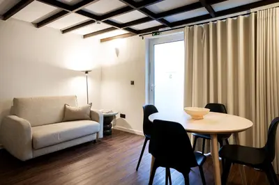 a living room with a table and a couch at Fine Arts Ateliers by Olala Homes in Porto