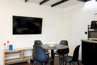 a living room with a table and chairs and a couch at Fine Arts Ateliers by Olala Homes in Porto