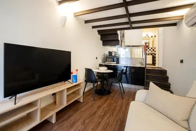 a kitchen with black chairs and a white table at Fine Arts Ateliers by Olala Homes in Porto