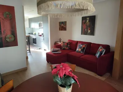 a living room with a red couch and a table at Arrábida Ruby Apartment in Vila Nova de Gaia