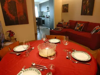 a table with plates and wine glasses on a red table cloth at Arrábida Ruby Apartment in Vila Nova de Gaia