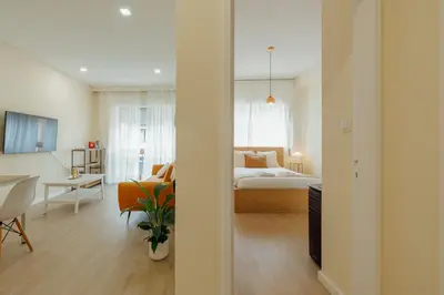 a bedroom with a bed and a living room at Santa Catarina Comfort by Vacationy in Porto