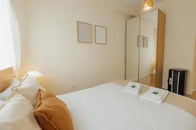a bedroom with a white bed with two pillows on it at Santa Catarina Comfort by Vacationy in Porto
