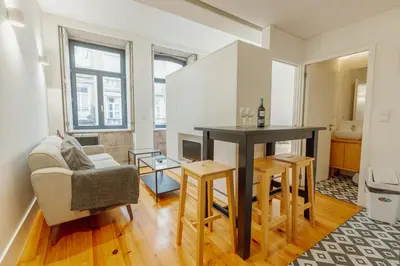a living room with a table and a chair at Bonfim 362 by Vacationy in Porto
