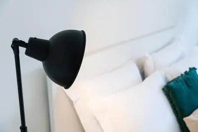 a microphone on a tripod next to a white couch at Studio-Fast Wi-Fi- AC -5 min Trindade Metro&Clérigos in Porto