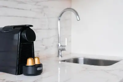 a kitchen counter with a coffee maker and a sink at Studio-Fast Wi-Fi- AC -5 min Trindade Metro&Clérigos in Porto