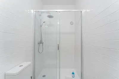 a white bathroom with a shower and a toilet at Studio-Fast Wi-Fi- AC -5 min Trindade Metro&Clérigos in Porto