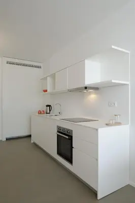 a white bathroom with a sink and a mirror at Urban Residences Sacadura in Porto