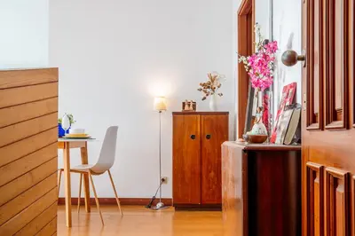 a room with a desk and a table with a chair at Skyline Invicta in Porto