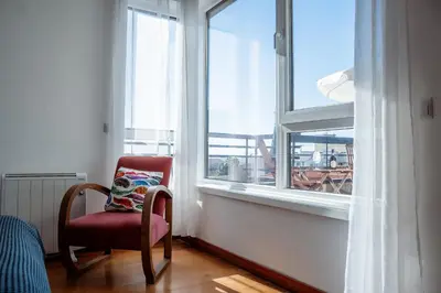 a chair sitting in a room with a window at Skyline Invicta in Porto