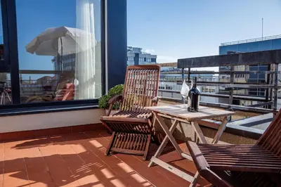 a patio with two chairs and a table on a balcony at Skyline Invicta in Porto