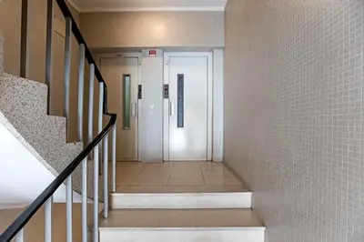 a hallway leading to a door in a building at Skyline Invicta in Porto
