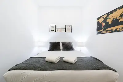 a bedroom with a white bed with two pillows at Cantinho do Porto - Metro 1 Minute Away in Porto