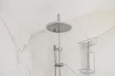 a shower in a bathroom with white marble at Sunny one bedroom apartment in Porto