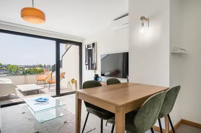 a dining room with a table and chairs at Sunny one bedroom apartment in Porto