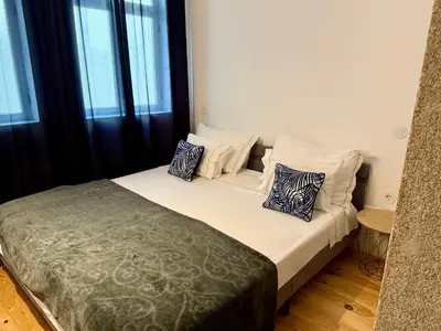 a living room with a table and a tv and stairs at Apartments City Center- Market Bolhão in Porto