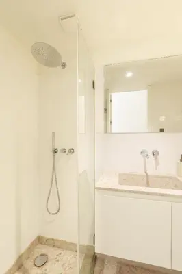 a white bathroom with a shower and a sink at VIVA Quinta Modernista Flat in Porto