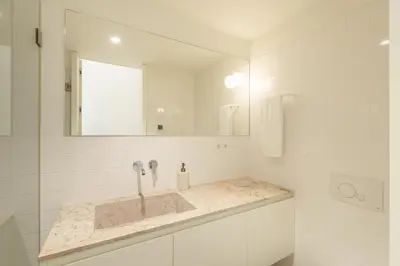 a bathroom with a sink and a mirror at VIVA Quinta Modernista Flat in Porto